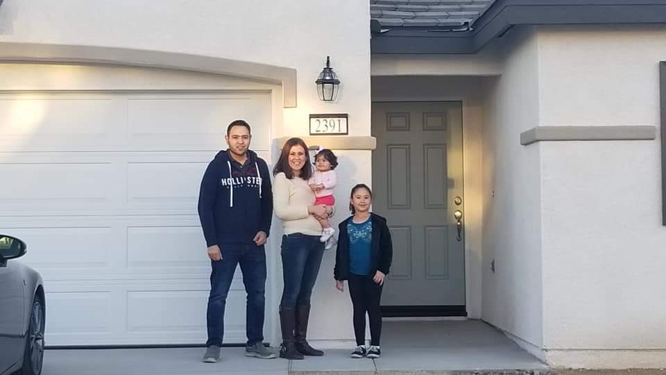 Monica C. and family with new home. lending by Valentina J. Estes of Benchmark Mortgage.